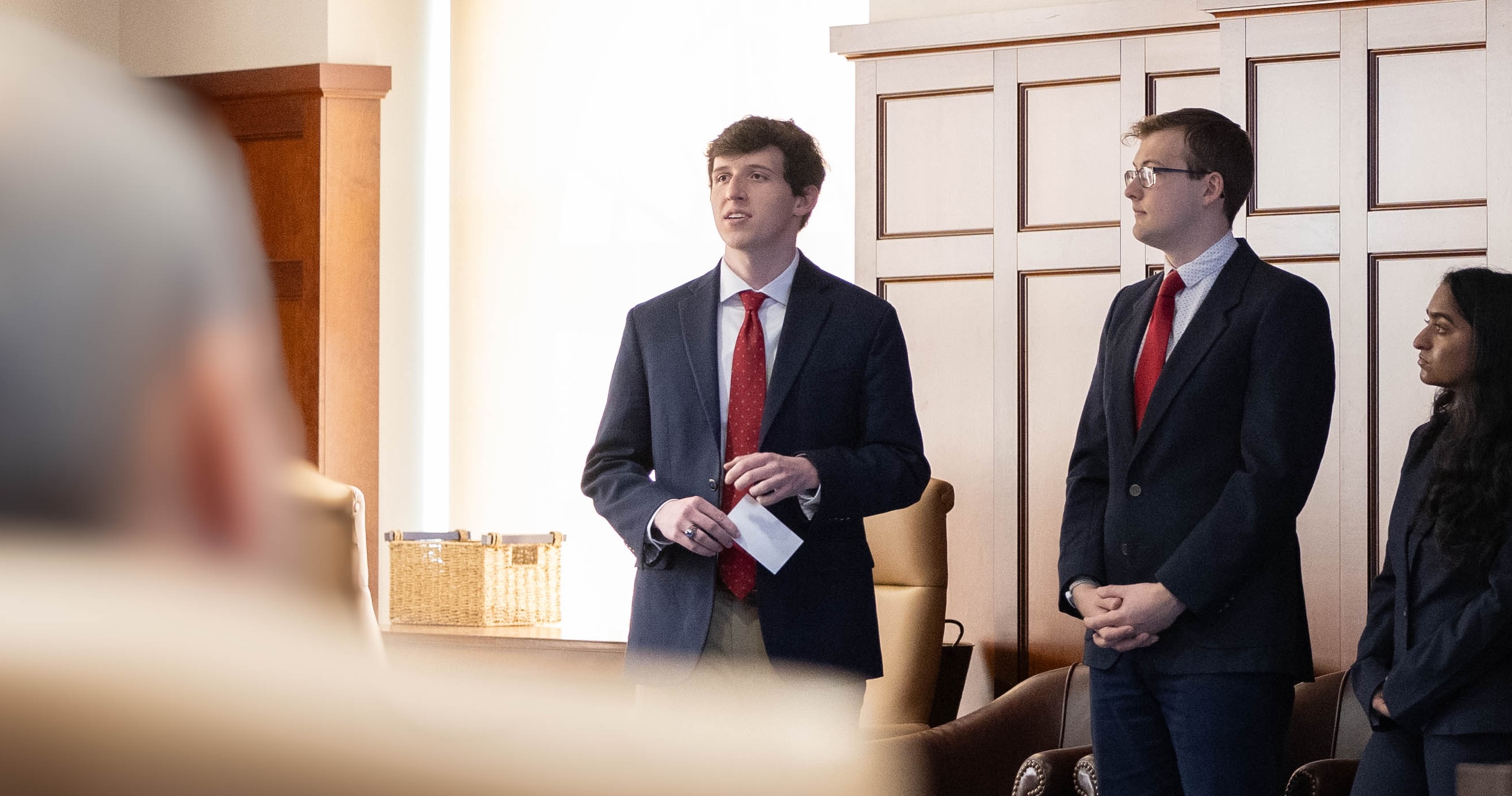 Will in a suit giving a briefing.